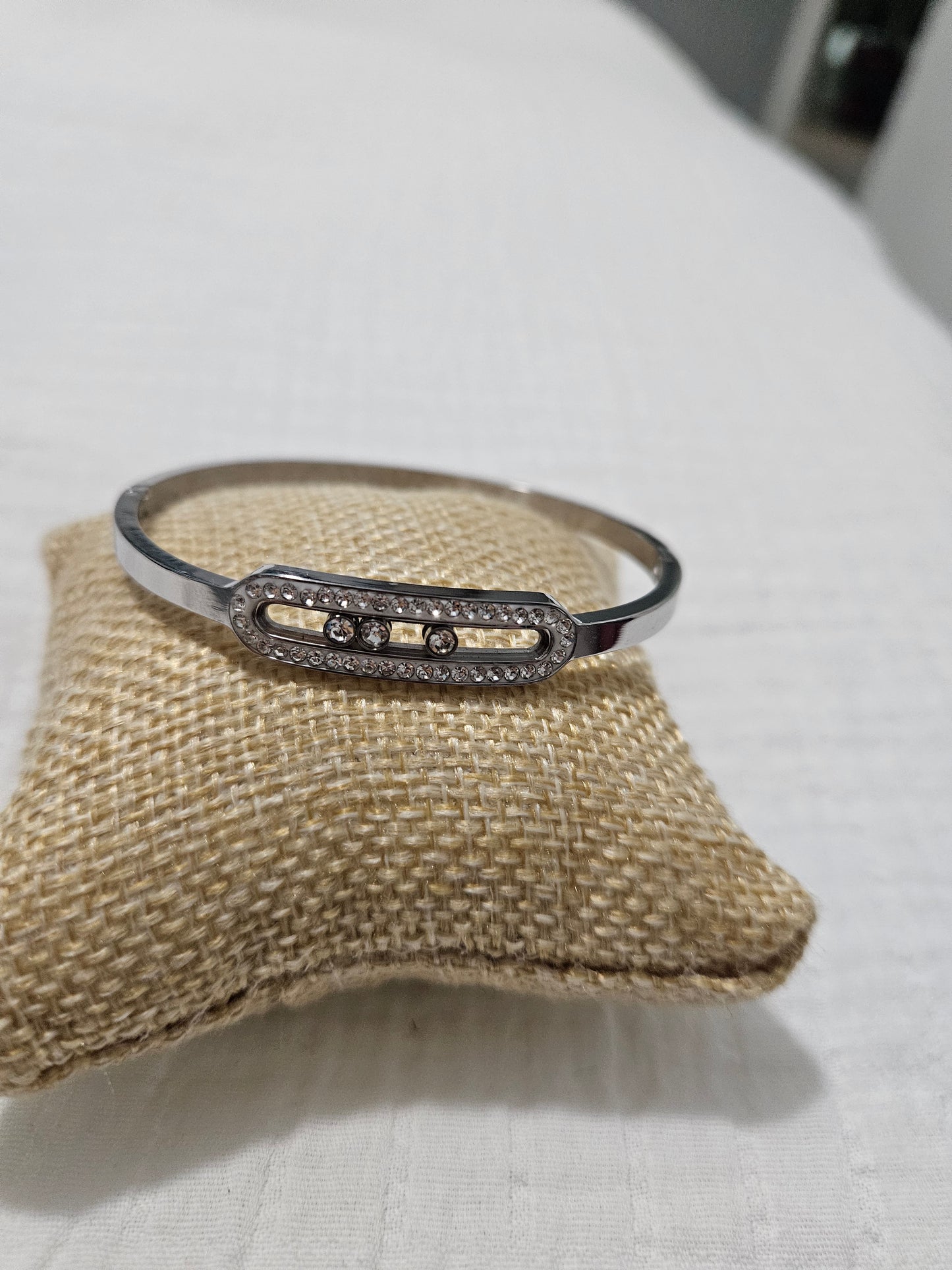 Silver bracelet with a bar and three diamonds that move inside.